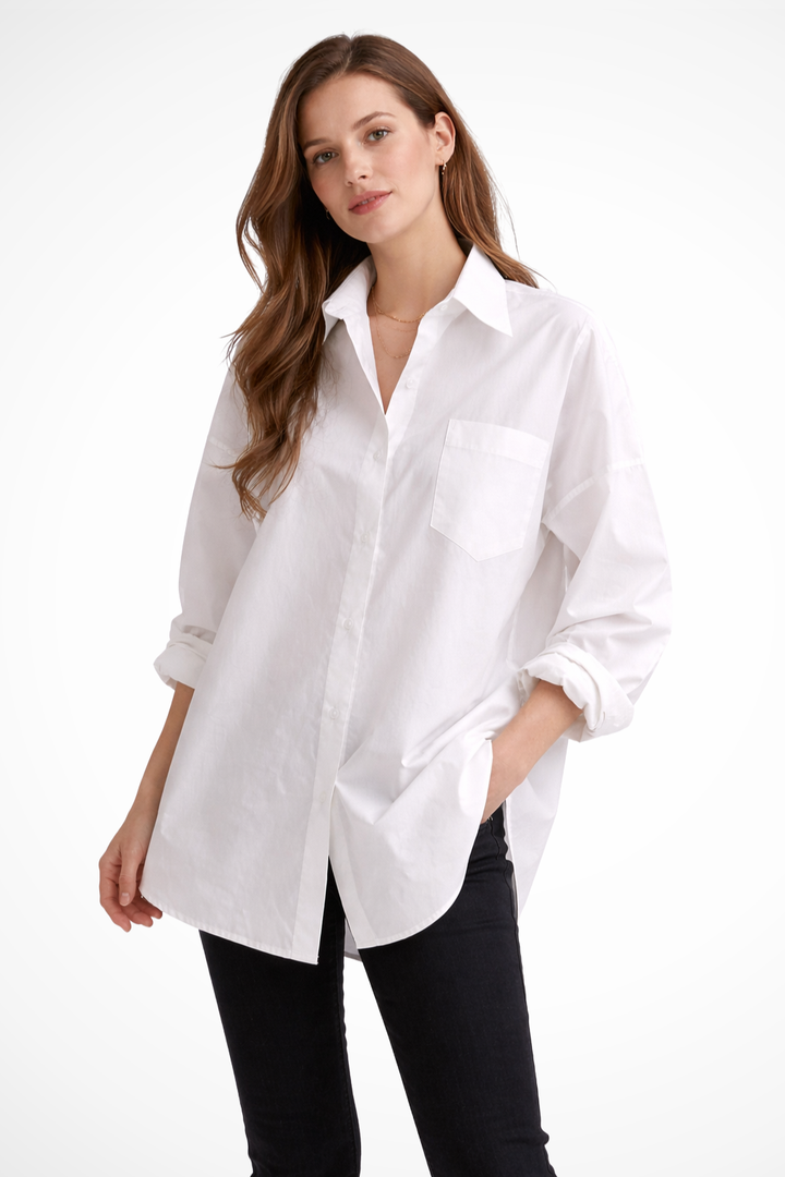 Women's white oversized button down long sleeve blouse, relaxed fit. Modern, versatile wardrobe essential.