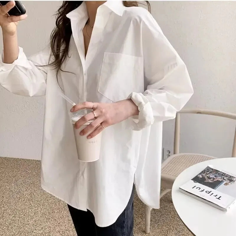 Modern women's white long sleeve oversized blouse. Relaxed fit button down shirt for a chic, effortless look.