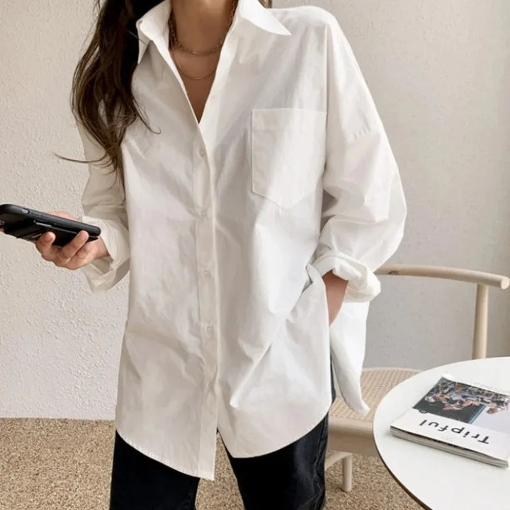 Stylish white long sleeve oversized shirt for women. Button down blouse, relaxed fit, modern everyday fashion.