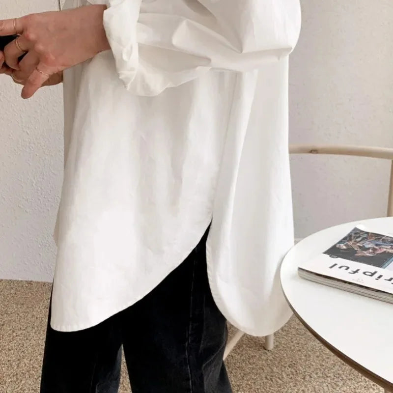 Effortless women's white button down long sleeve blouse. Oversized, relaxed fit top, perfect for modern style.