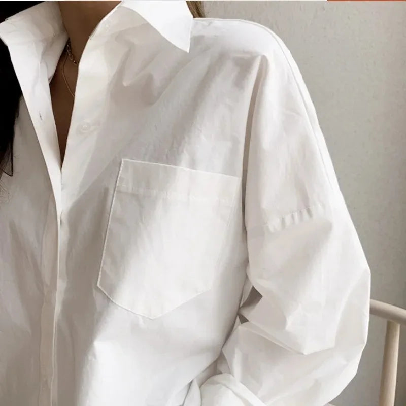 White oversized long sleeve blouse. Women's relaxed fit button down shirt, versatile for a modern, chic style.