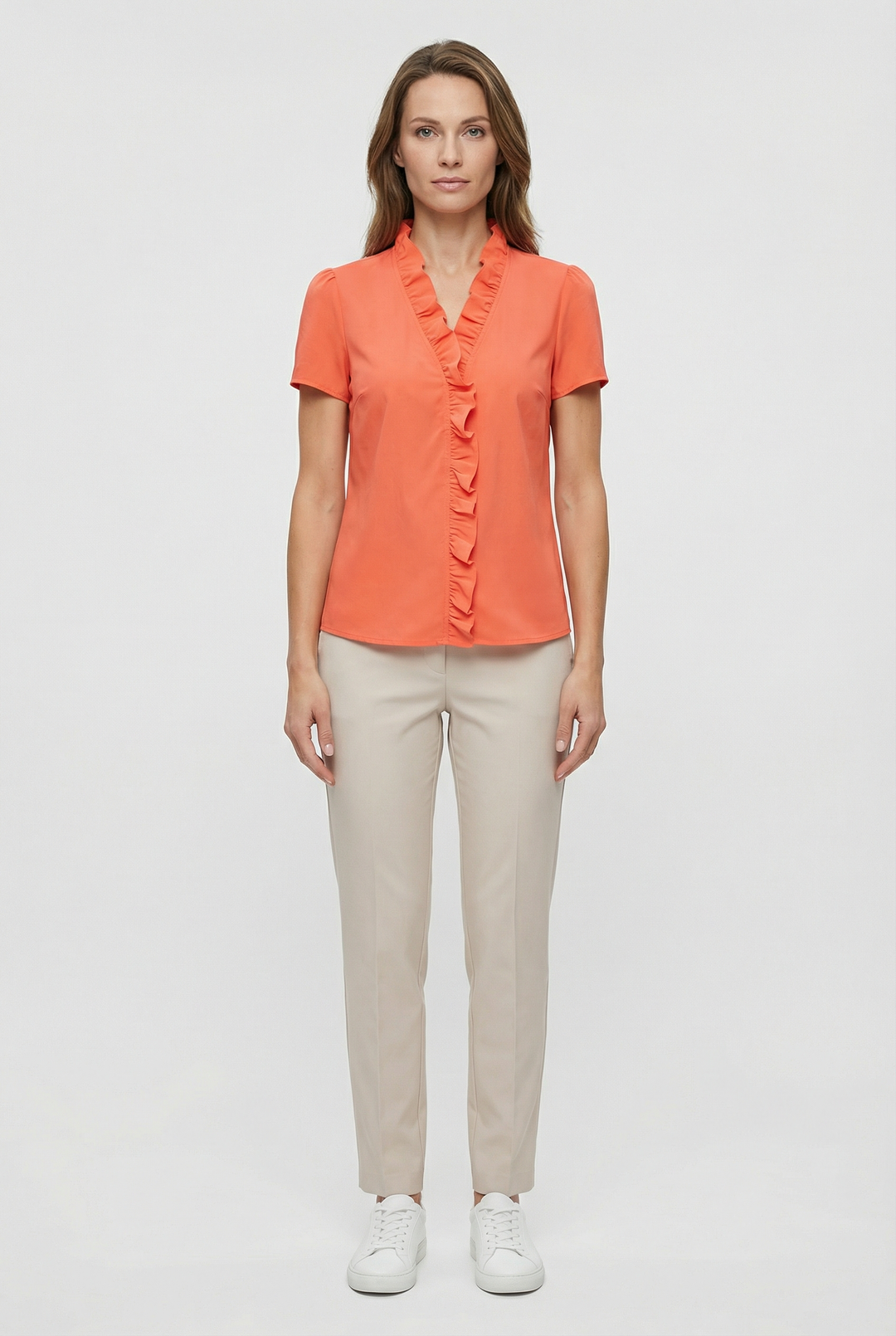 Detailed view of the flattering neckline on a women's ruffled long sleeve blouse.