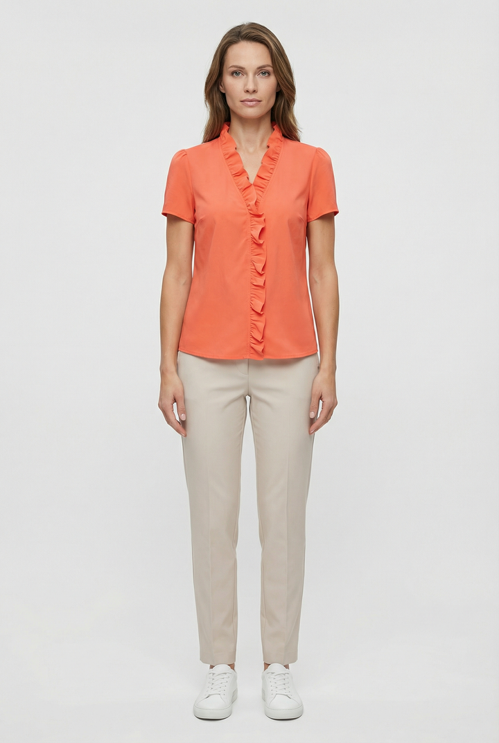 Detailed view of the flattering neckline on a women's ruffled long sleeve blouse.