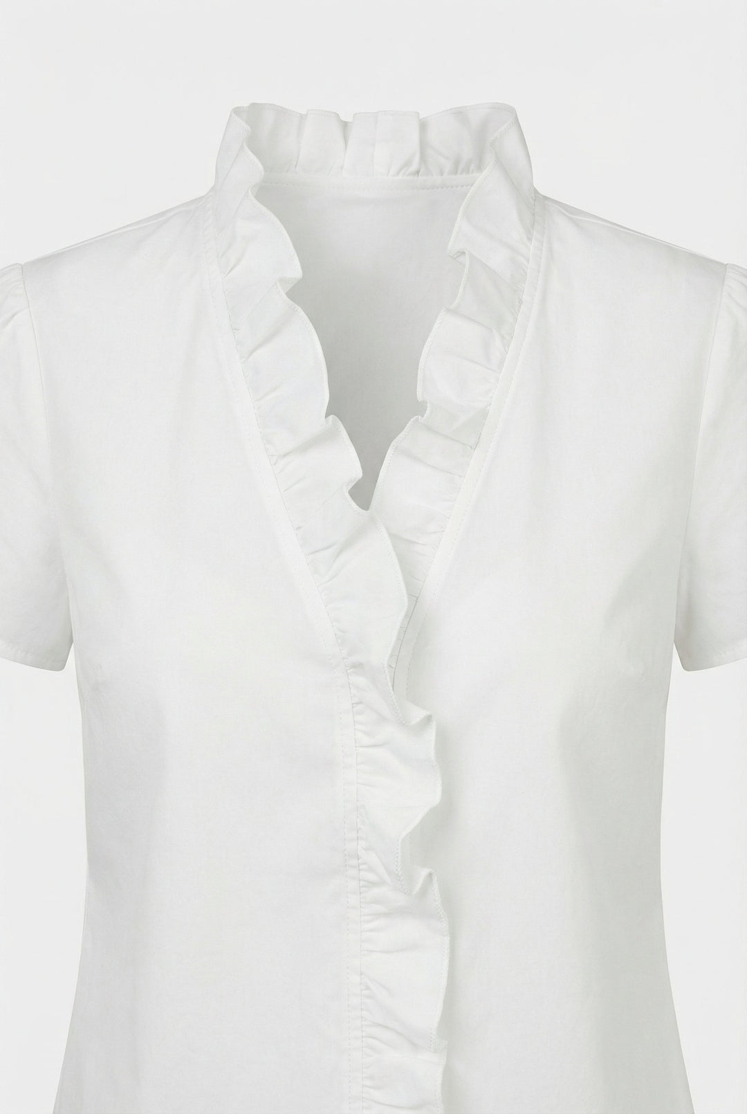 Close-up of delicate ruffles on a women's long sleeve casual blouse.
