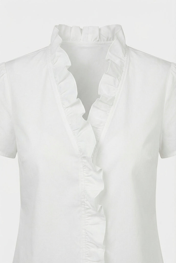 Close-up of delicate ruffles on a women's long sleeve casual blouse.