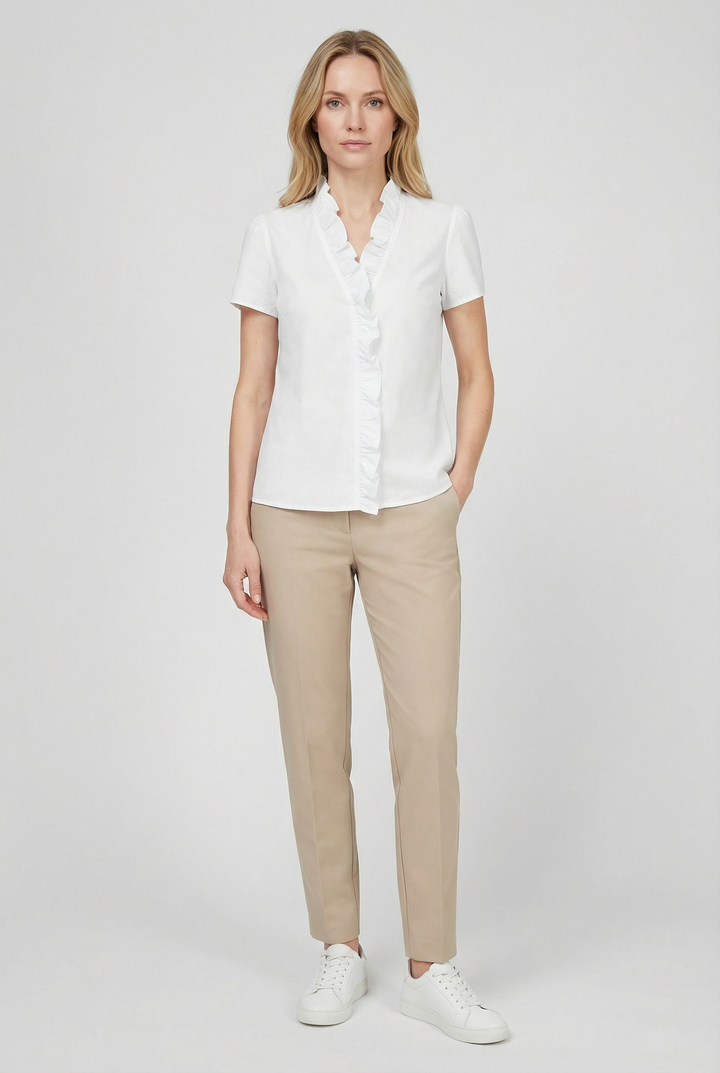 Model wearing a women's chic ruffled long sleeve blouse in a spring fashion setting.