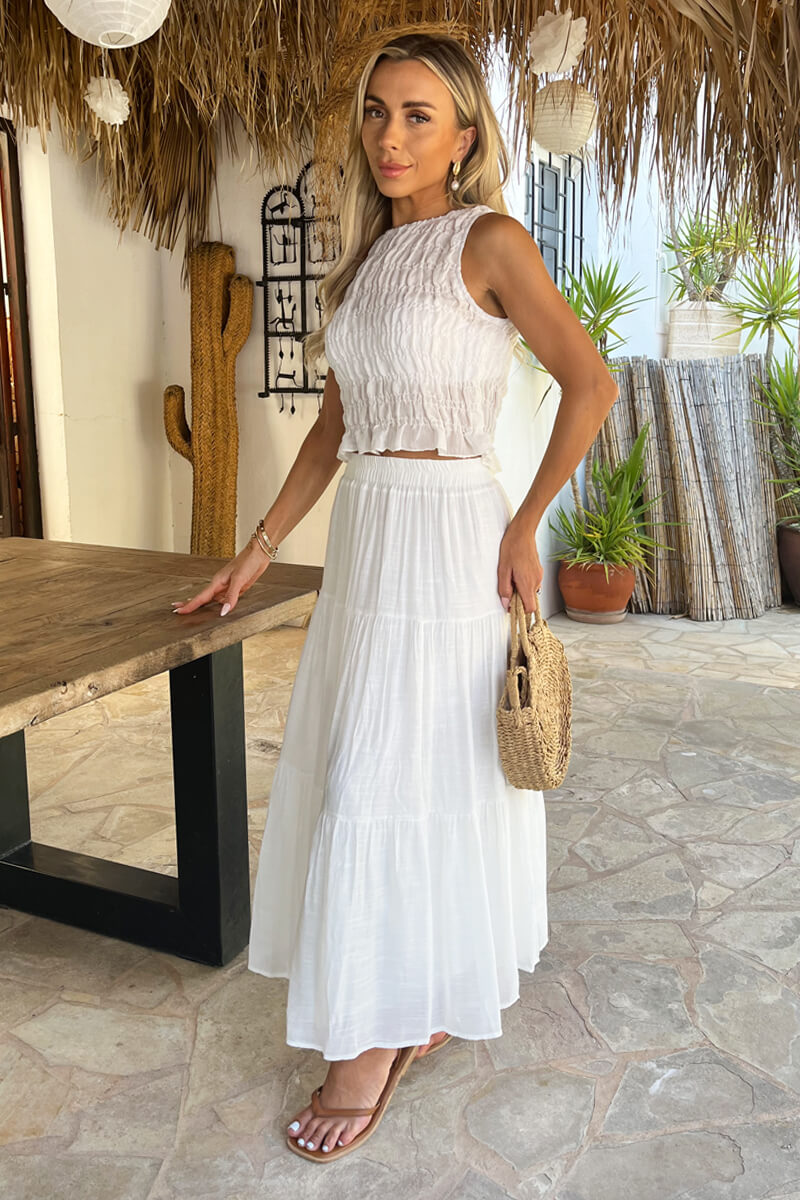 Stylish women's high-waist white tiered midi skirt, a versatile and airy choice for warm weather outfits.