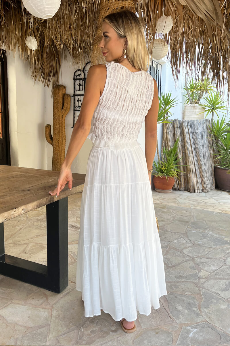 Full shot of a model wearing a women's white tiered midi skirt, perfect for a chic summer casual look.