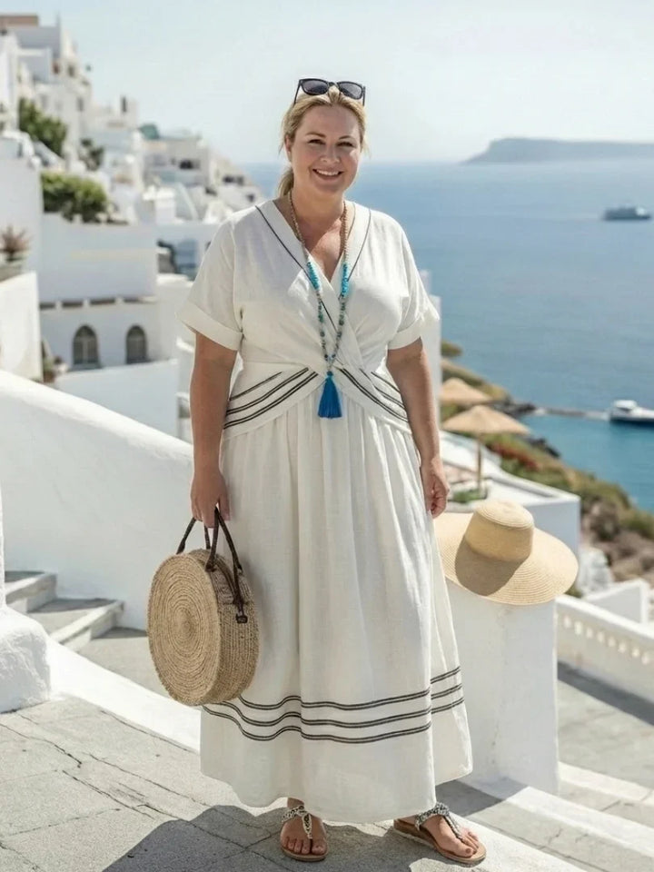 Close-up of a white women's wrap midi dress with a flattering V-neck and chic striped short-sleeves.