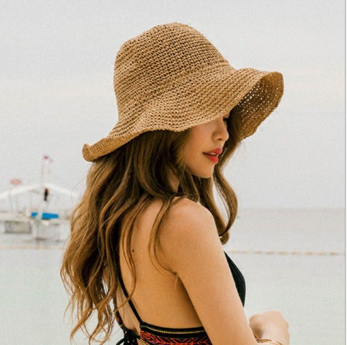 Women's wide brim crochet straw bucket hat for summer sun protection.