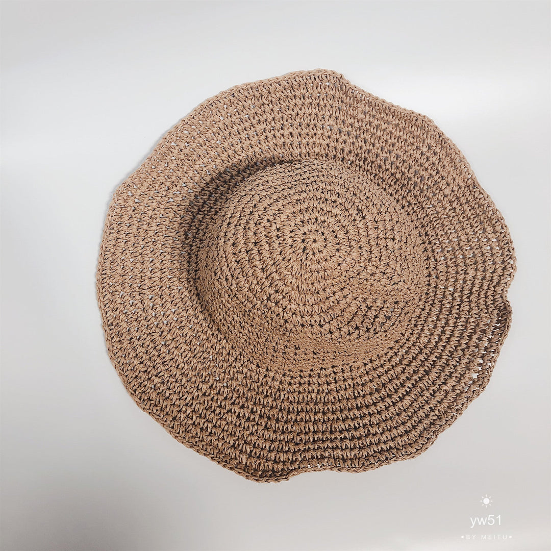 Women's wide brim crochet straw bucket hat, a chic summer accessory for sun protection.