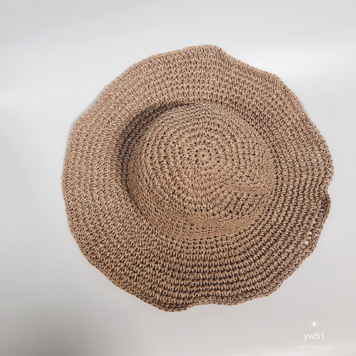 Women's wide brim crochet straw bucket hat, a chic summer accessory for sun protection.