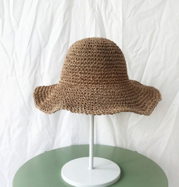 Lightweight women's wide brim crochet straw bucket hat for summer casual wear.