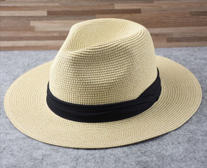 Stylish women's wide brim straw hat, Panama style, ideal for sun protection on beach trips.