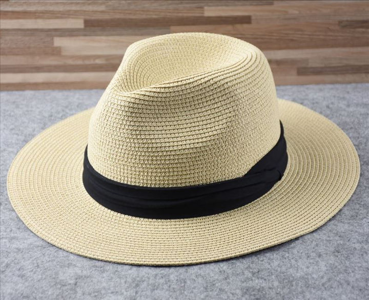 Stylish women's wide brim straw hat, Panama style, ideal for sun protection on beach trips.