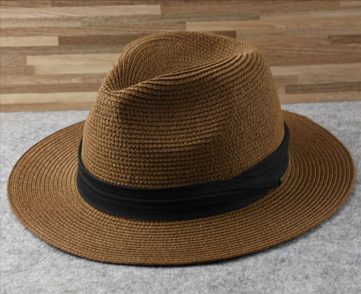 Chic women's straw sun hat with wide brim, excellent for summer outdoor activities & sun protection.