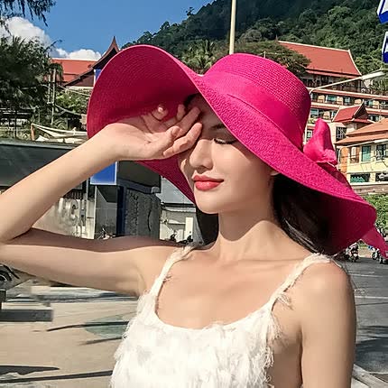 Stylish straw sun hat for women, featuring a wide brim and chic bow accent.