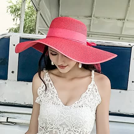 Beach-ready wide brim straw hat for women, offering sun protection and fashion.