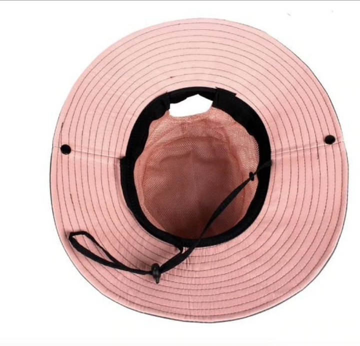 Stylish women's wide-brim UV sun hat with ponytail opening, adjustable & foldable for summer.