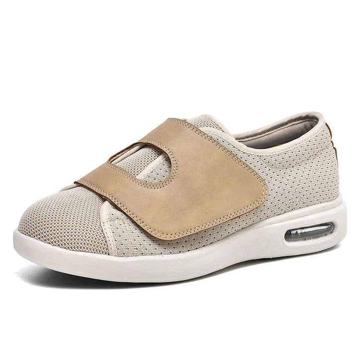 Orthotic friendly women's wide fit slip-on sneakers, ideal for walking, secured with an adjustable Velcro strap.