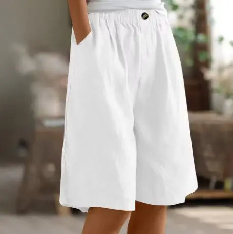Woman in motion, highlighting the flowing wide leg & comfortable high waist of these summer casual shorts.