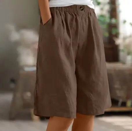 Flat lay: Women's wide leg high waist elastic shorts, emphasizing relaxed fit & casual summer comfort.