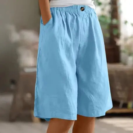 Woman on vacation in comfortable wide leg high waist shorts, effortless summer style for relaxed outfits.
