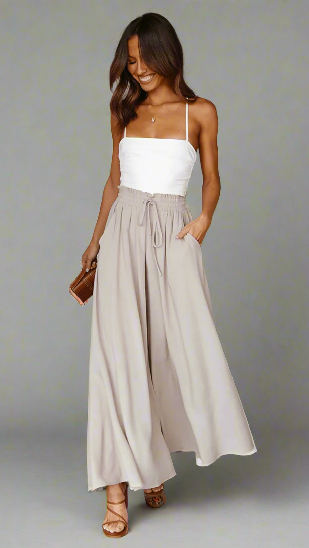 Relaxed fit wide-leg women's pants with comfortable elastic waist, ideal for comfort.