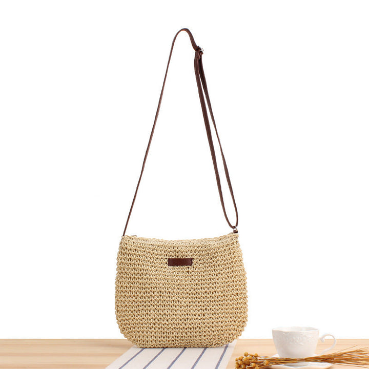 Women's woven shoulder bag with detachable strap, natural material. Stylish crossbody handbag in beige for everyday fashion.