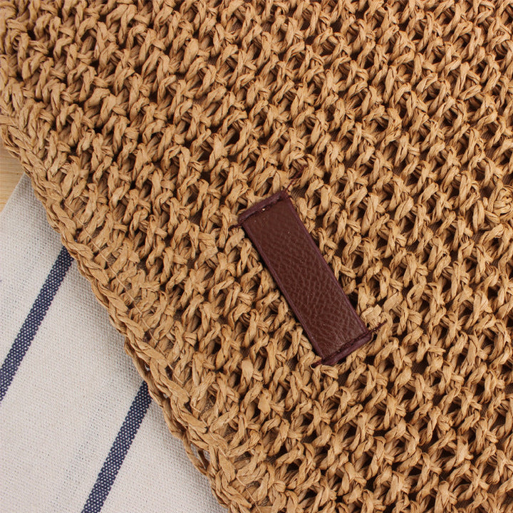 Stylish women's woven handbag with a detachable strap, convertible to a crossbody. Natural material beige shoulder bag.