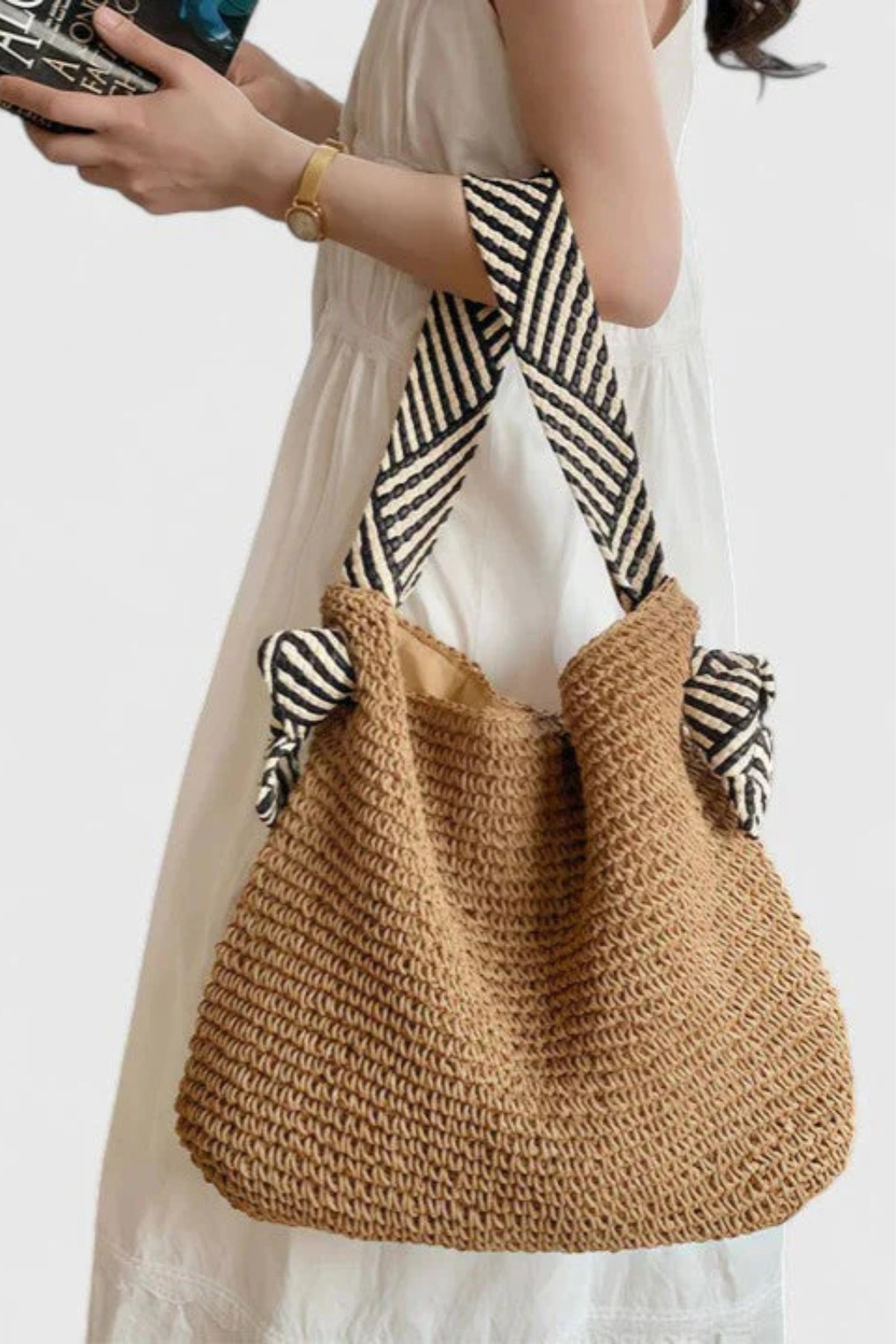 Chic women's woven straw shoulder bag, a versatile tote with eye-catching contrast straps for daily use.