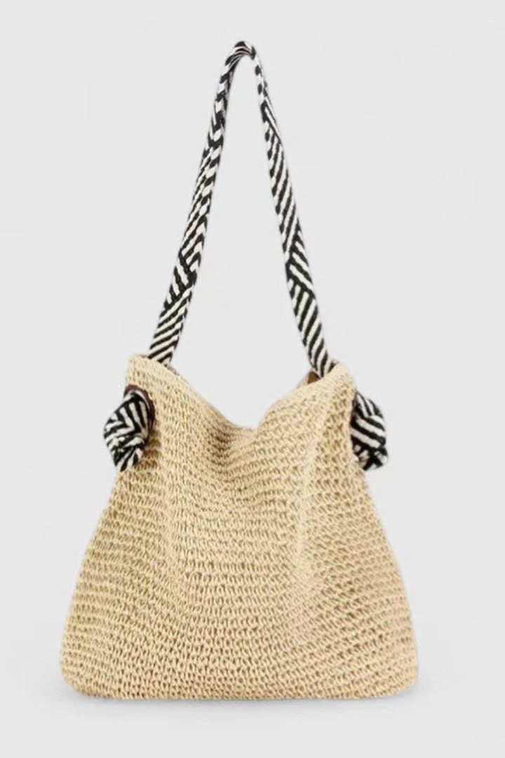 Women's woven straw shoulder tote bag, a lightweight summer essential with practical contrast straps.