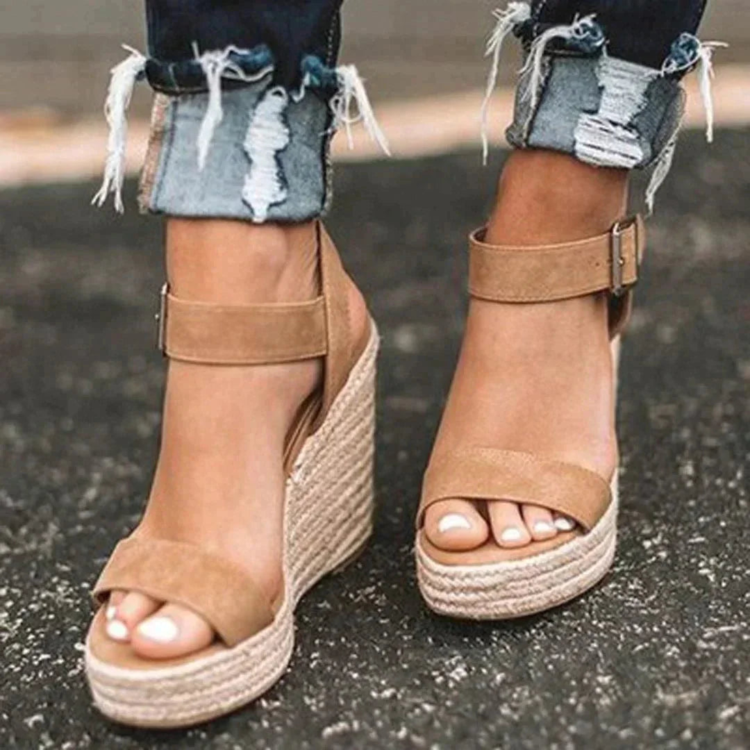 Women's woven wedge open-toe sandals with adjustable ankle buckle, ideal for comfortable summer wear.