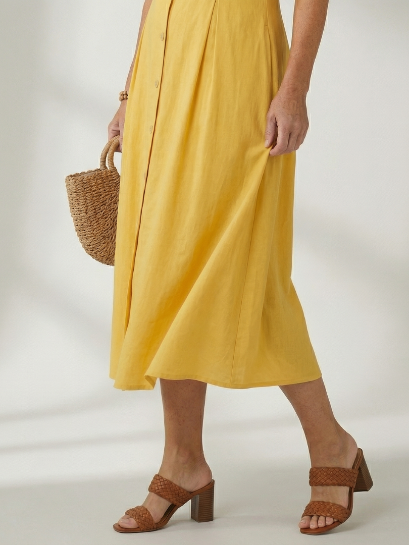 Effortless blue sleeveless midi dress, button-front design, perfect for summer style.