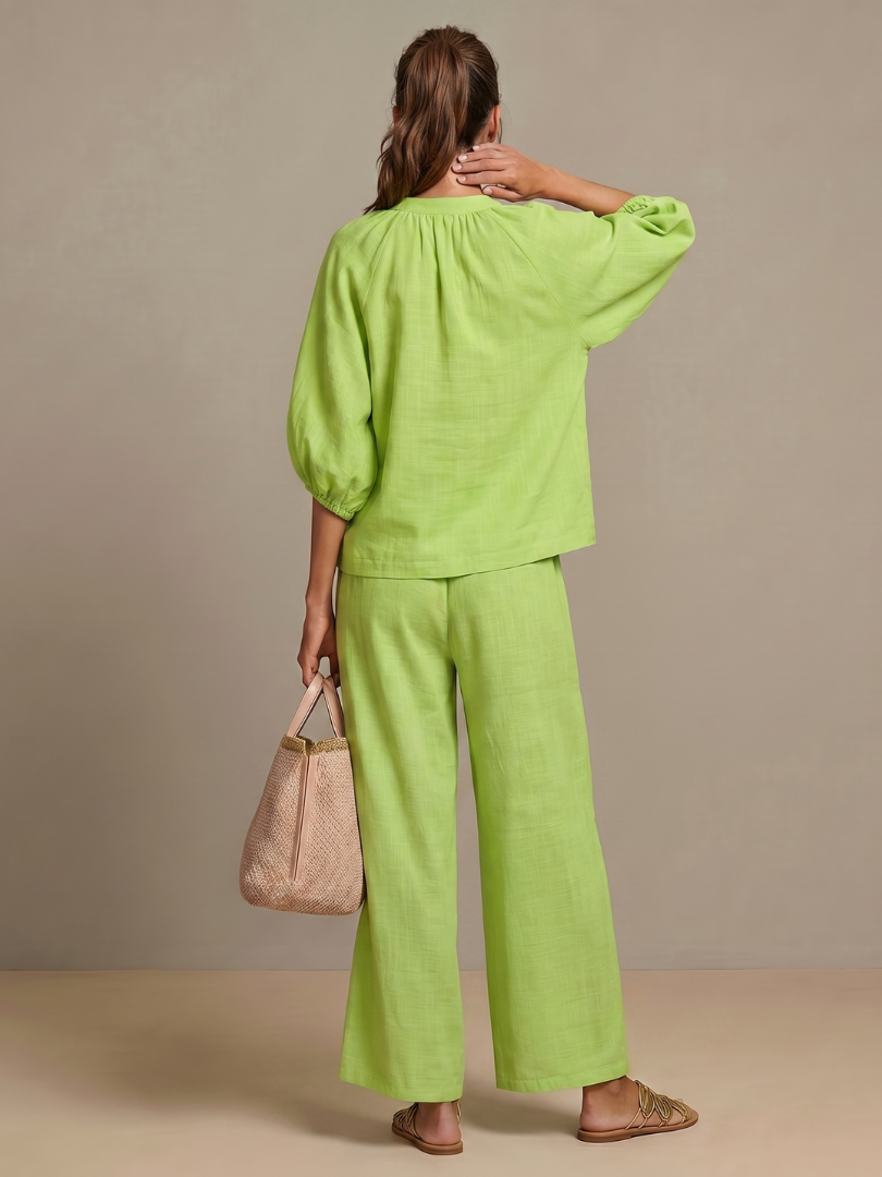 Chic black women's zip front blouson top & wide leg pant set, elegant and comfortable.