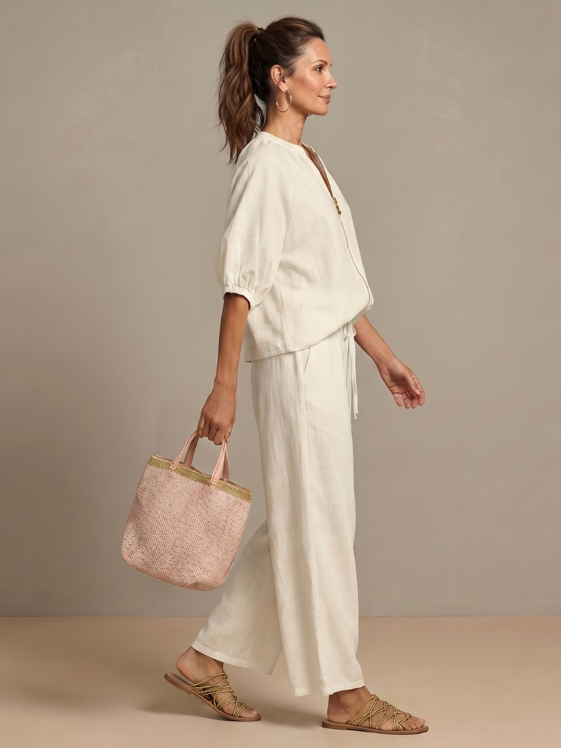 Detail of wide leg pants from the women's matching blouson top set, showing elegant drape.