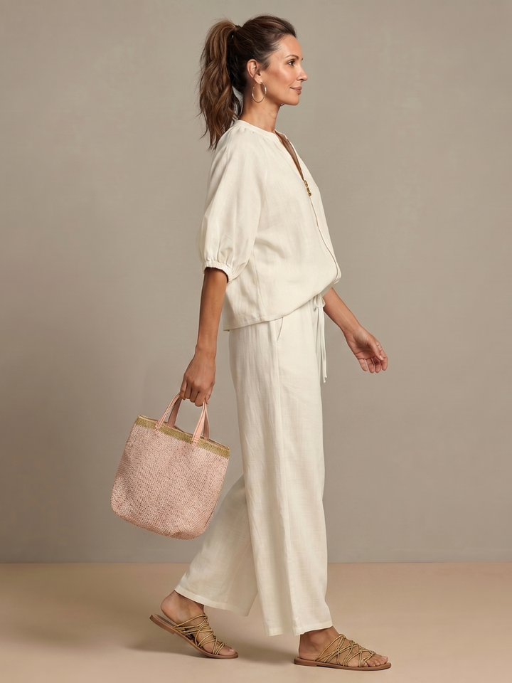 Detail of wide leg pants from the women's matching blouson top set, showing elegant drape.