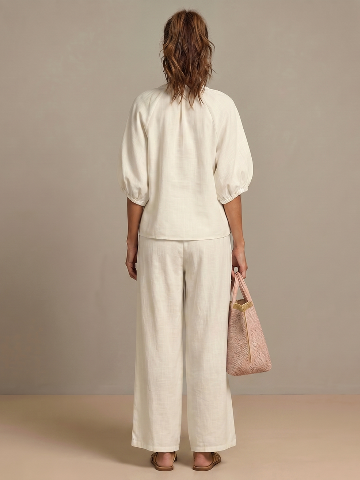 Elegant women's matching set with a zip front blouson top & chic wide leg pants.