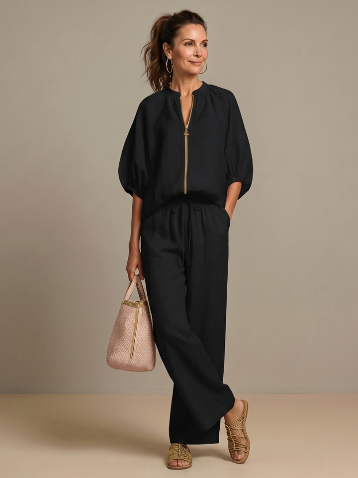 Women's blouson top & wide leg pant set, laid flat to showcase versatile fabric and cut.