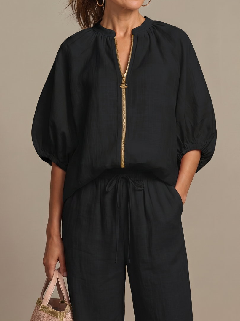 Stylish women's blouson top with zip front and wide leg pants, a coordinated fashion set.