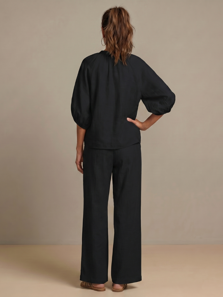 Fashionable wide leg pants with a matching zip front blouson top, women's two-piece ensemble.