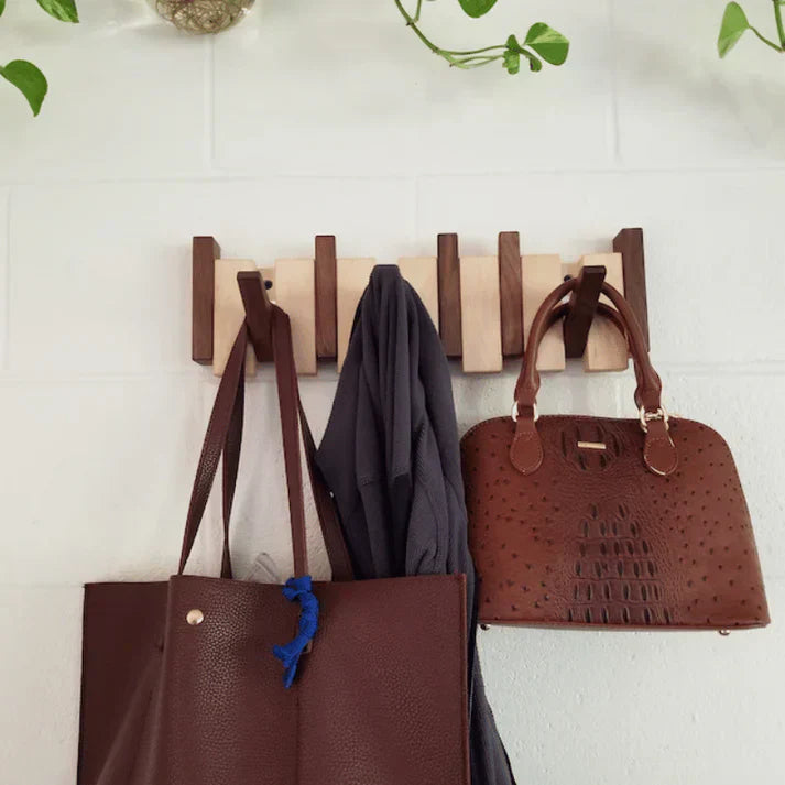 Wall-mounted wooden rack with piano keys as coat hooks