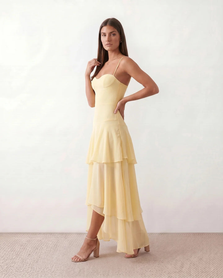 Elegant flowy yellow maxi dress for women, with thin spaghetti straps, ideal for casual summer or vacation.