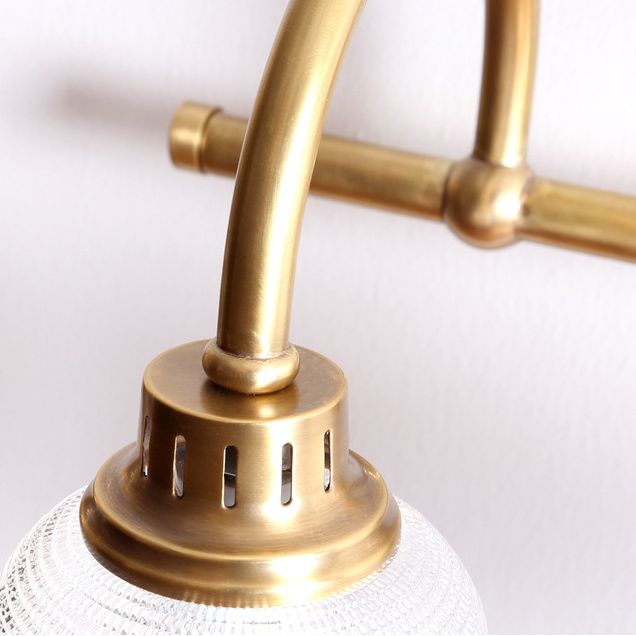 Beautiful antique brass indoor wall light, elegant modern classic design with a glass shade.