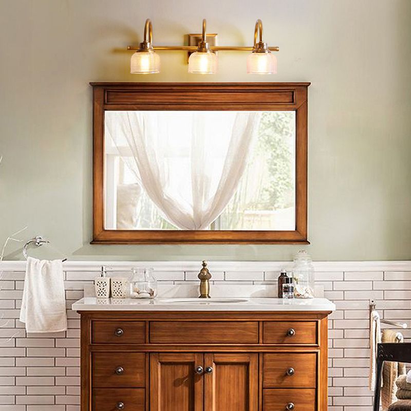Antique brass vanity light for bathroom, hardwired indoor wall lamp with glass shade.