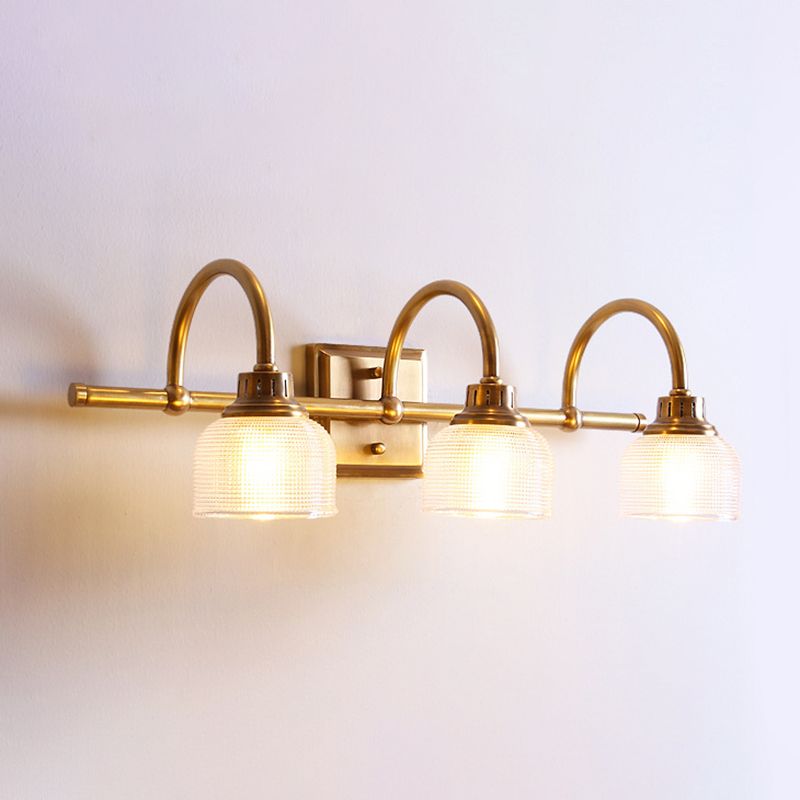 Elegant antique brass indoor wall lamp, a modern classic hardwired light with glass shade.