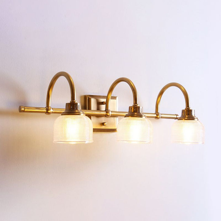 Elegant antique brass indoor wall lamp, a modern classic hardwired light with glass shade.