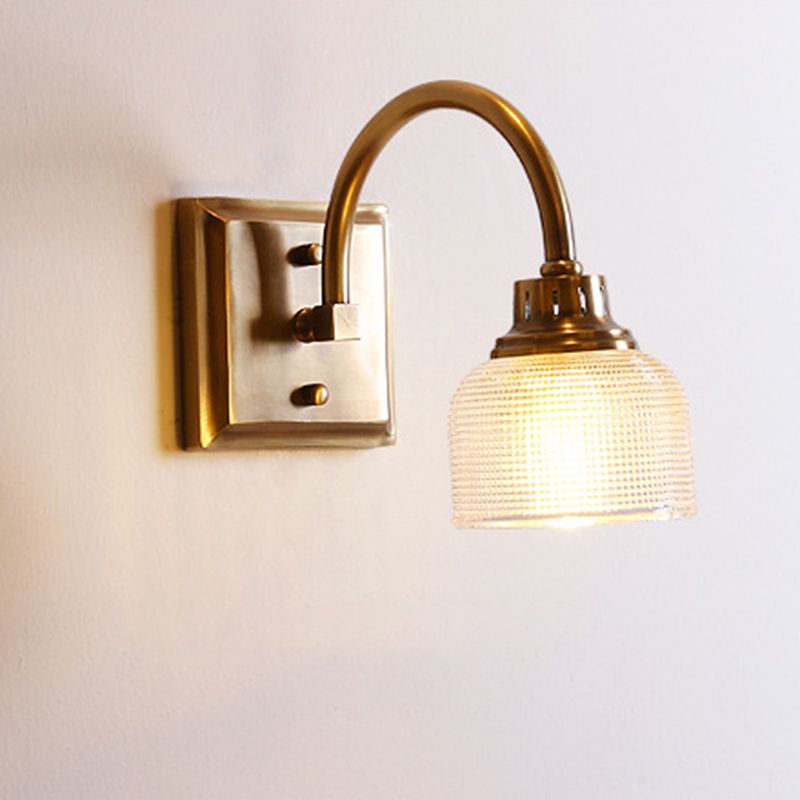 Stylish antique brass bathroom wall light, hardwired elegant lighting with glass shade.